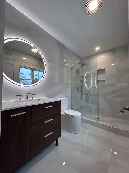 Bathroom with a polished marble-style floor and glass shower