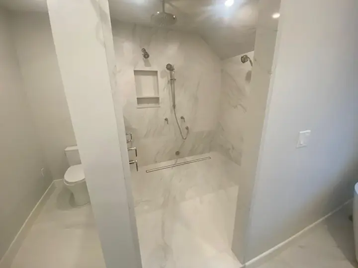 Bright marble-style bathroom with a walk-in shower