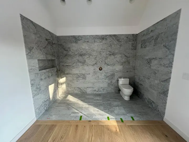 Gray marble-style bathroom walls with a niche, ready for fixtures