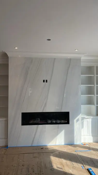Fireplace feature wall in large-format marble-style tile