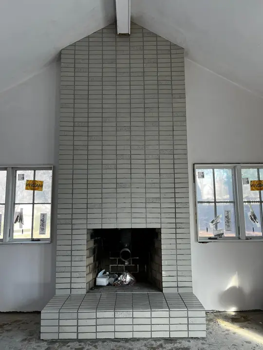Floor-to-ceiling fireplace in white brick-style tile