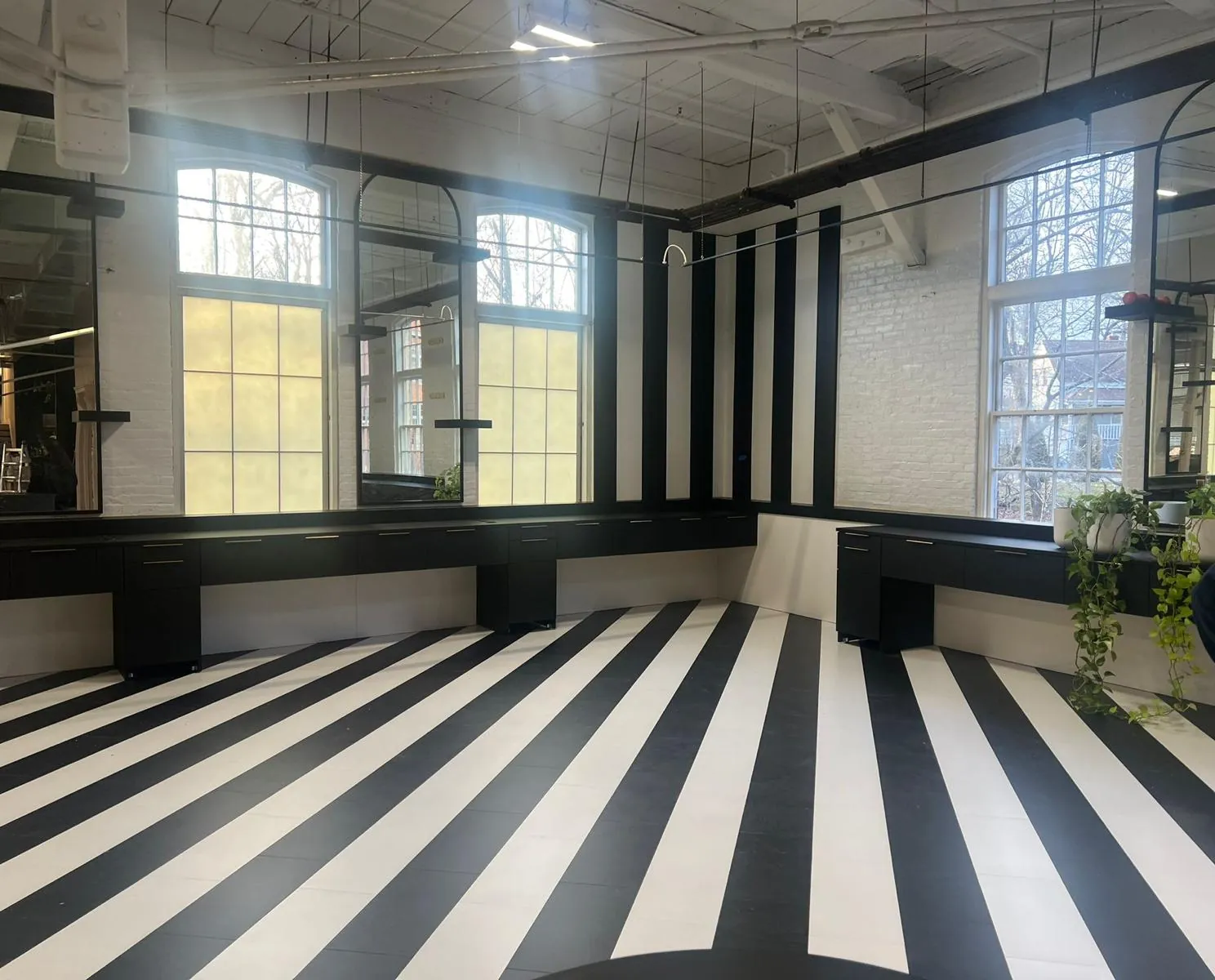 Bold black-and-white striped tile floor in a commercial space