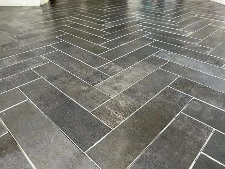 Charcoal plank tile laid in herringbone