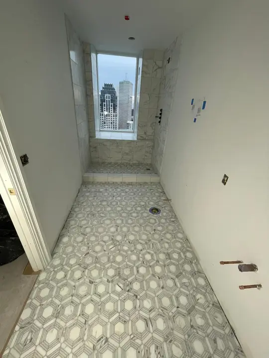 Hallway with a patterned mosaic tile floor