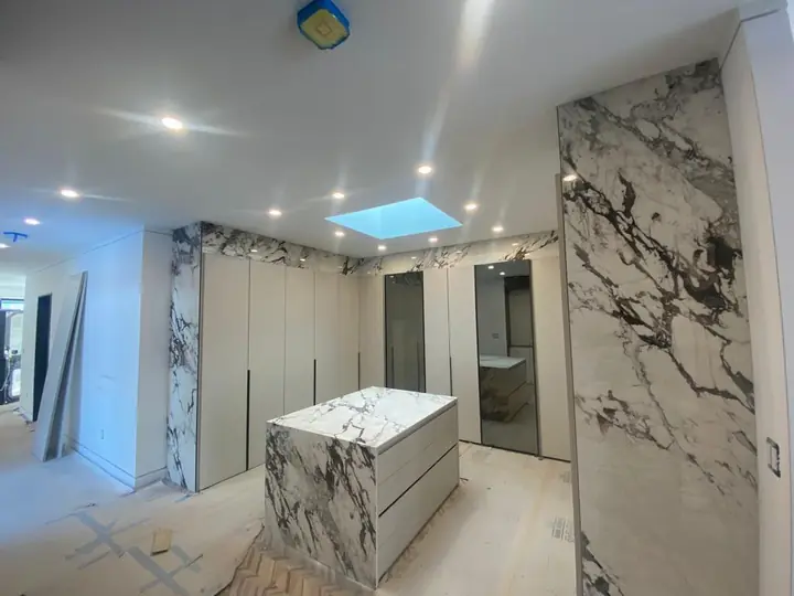 Kitchen island and walls in dramatic marble-style slab tile
