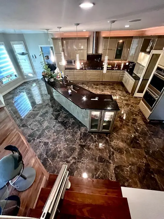 Open kitchen with a polished dark marble-style floor